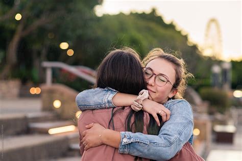 female friends by the sea - four friends hugging stock pictures, royalty-free photos & images. . Images of friends hugging